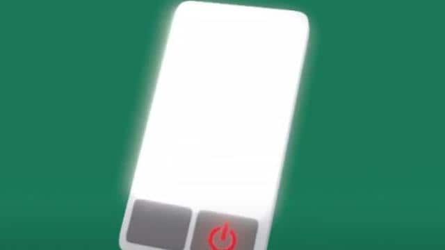 Uma tela de smartphone brilhante com um símbolo de botão liga/desliga na parte inferior, sobre um fundo verde.